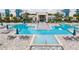 Aerial view of resort-style pool and hot tub with lounge chairs at 7740 Sandy Ridge Dr # 218, Reunion, FL 34747