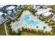 Community pool with multiple areas, lounge chairs, and patio at 7740 Sandy Ridge Dr # 218, Reunion, FL 34747