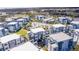 Aerial view of modern townhouses with a community pool and golf course nearby at 7740 Sandy Ridge Dr # 218, Reunion, FL 34747