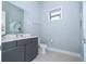 Modern bathroom with gray vanity and white toilet at 7740 Sandy Ridge Dr # 218, Reunion, FL 34747