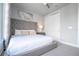King bedroom with tufted headboard and plenty of natural light at 7740 Sandy Ridge Dr # 218, Reunion, FL 34747