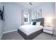 Bedroom with TV, window, and nightstand at 7740 Sandy Ridge Dr # 218, Reunion, FL 34747