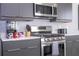 Modern kitchen with stainless steel appliances and gas range at 7740 Sandy Ridge Dr # 218, Reunion, FL 34747