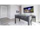 Game room with foosball table and large TV at 7740 Sandy Ridge Dr # 218, Reunion, FL 34747
