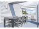 Private balcony with outdoor dining set and lounge chairs at 7740 Sandy Ridge Dr # 218, Reunion, FL 34747