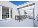 Private balcony with outdoor dining furniture and lounge chairs at 7740 Sandy Ridge Dr # 218, Reunion, FL 34747