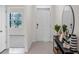 Bright and airy entryway with tile flooring, console table, and large mirror at 4141 Singing Mockingbird Blvd, Bartow, FL 33830