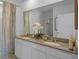 Double vanity bathroom with granite countertop and a large mirror at 4145 Singing Mockingbird Blvd, Bartow, FL 33830