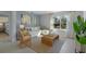 Living room featuring a beige sectional sofa and wicker accent chair at 4145 Singing Mockingbird Blvd, Bartow, FL 33830