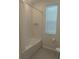 Bathroom with tub shower and window at 12500 Encore At Ovation Way, Winter Garden, FL 34787