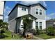 Two-story house with gray siding, stone accents, and a welcoming porch at 12500 Encore At Ovation Way, Winter Garden, FL 34787