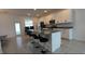 Modern kitchen with white cabinets, granite countertops, and an island at 12500 Encore At Ovation Way, Winter Garden, FL 34787