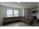 Spacious living room with a large sectional sofa and tile floors at 12500 Encore At Ovation Way, Winter Garden, FL 34787