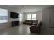 Living room with sectional sofa, large TV, and fireplace at 12500 Encore At Ovation Way, Winter Garden, FL 34787