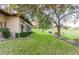 Landscaped backyard with lush lawn and mature trees at 38748 Lakeview Walk, Lady Lake, FL 32159