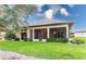 House exterior showcasing the backyard and screened patio at 38748 Lakeview Walk, Lady Lake, FL 32159