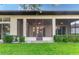 Home exterior showcasing a screened patio and landscaping at 38748 Lakeview Walk, Lady Lake, FL 32159