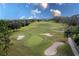 Aerial view of a lush green golf course with sand traps and a putting green at 38748 Lakeview Walk, Lady Lake, FL 32159