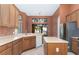 Spacious kitchen with an island, wood cabinets, and view to backyard at 38748 Lakeview Walk, Lady Lake, FL 32159