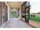 Large screened porch with sliding glass doors and access to backyard at 38748 Lakeview Walk, Lady Lake, FL 32159