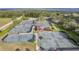 Aerial view of a community with multiple tennis courts and clubhouse at 38748 Lakeview Walk, Lady Lake, FL 32159