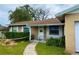 Front view of a house with a walkway and landscaping at 7012 Clarcona Ocoee Rd, Orlando, FL 32818