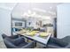 Elegant dining area with a glass-top table and gray chairs at 3191 Paradox Cir # 406, Kissimmee, FL 34746