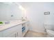 Clean bathroom with double vanity, neutral tile, and bright lighting at 3191 Paradox Cir # 406, Kissimmee, FL 34746