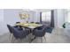 Modern dining area with a glass-top table and gray chairs at 3191 Paradox Cir # 406, Kissimmee, FL 34746
