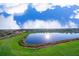 Community boasts a scenic lake surrounded by lush greenery and homes at 3191 Paradox Cir # 406, Kissimmee, FL 34746