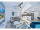 Bright living room features a comfortable sofa, large TV, and open kitchen view at 3191 Paradox Cir # 406, Kissimmee, FL 34746