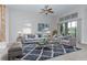 Spacious living room with comfortable seating, a large rug, and access to the outdoors at 38748 Lakeview Walk, Lady Lake, FL 32159