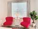 Relaxing sitting area with two pink armchairs and a side table at 2809 Almaton Loop # 304, Kissimmee, FL 34747