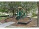Small playground with a slide and climbing structure, nestled among the trees at 2809 Almaton Loop # 304, Kissimmee, FL 34747