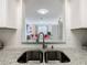 Kitchen sink with granite countertops and a view into living area at 2809 Almaton Loop # 304, Kissimmee, FL 34747