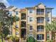 Three-story building with multiple balconies and palm trees at 2809 Almaton Loop # 304, Kissimmee, FL 34747