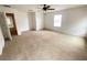 Large bedroom with ceiling fan and carpet flooring at 1513 Blue Sky Way, Clermont, FL 34714