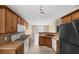 Well-equipped kitchen with wood cabinetry and tiled flooring at 217 Winding Cove Ave, Apopka, FL 32703