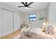 Bedroom with white closet doors and ceiling fan at 2445 Sanford Ave, Sanford, FL 32771