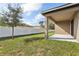 Covered patio and grassy backyard with fence at 279 Fig Ct, Poinciana, FL 34759