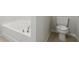 Clean bathroom with a toilet and bathtub at 279 Fig Ct, Poinciana, FL 34759