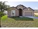Two-story house with a two-car garage, and front yard at 279 Fig Ct, Poinciana, FL 34759