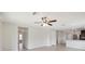 Open living room with tile floors, high ceilings, and access to kitchen and hallway at 279 Fig Ct, Poinciana, FL 34759