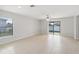 Bright living room with tile floors and sliding glass doors leading to the backyard at 279 Fig Ct, Poinciana, FL 34759