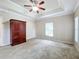 Spacious bedroom with ceiling fan, carpet flooring, and a large closet at 944 Hicks Rd, Lakeland, FL 33813