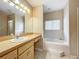 Bathroom features a vanity with storage, tub, and a separate shower at 944 Hicks Rd, Lakeland, FL 33813