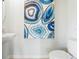 Small half-bathroom with white sink and toilet, featuring blue agate artwork at 2711 Golden Trout Ln, Edgewater, FL 32141