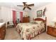Main bedroom with floral bedding, dresser, and ceiling fan at 280 Windmeadows St, Altamonte Springs, FL 32701