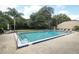 Community pool with surrounding patio furniture and landscaping at 280 Windmeadows St, Altamonte Springs, FL 32701