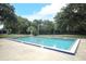 Community pool with surrounding trees and patio furniture at 280 Windmeadows St, Altamonte Springs, FL 32701
